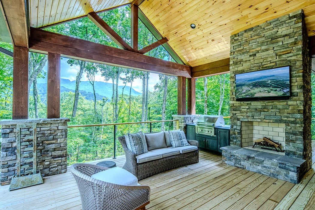 Covered deck with fireplace and views of the mountains